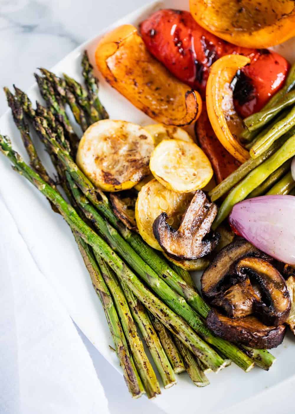 Perfectly charred grilled vegetables that are tender and full of flavor. The best summer side dish that can be ready in 20 minutes or less! Grilled asparagus, mushrooms, squash, green beans and bell peppers.