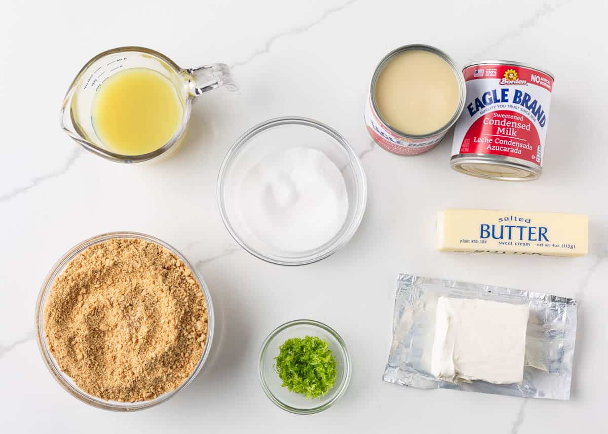 Key lime pie bars are made with a buttery graham cracker crust and creamy key lime filling. They're an easy, vibrant dessert with a delightful sweet and tangy flavor! Key Lime Bar ingredients on the counter.