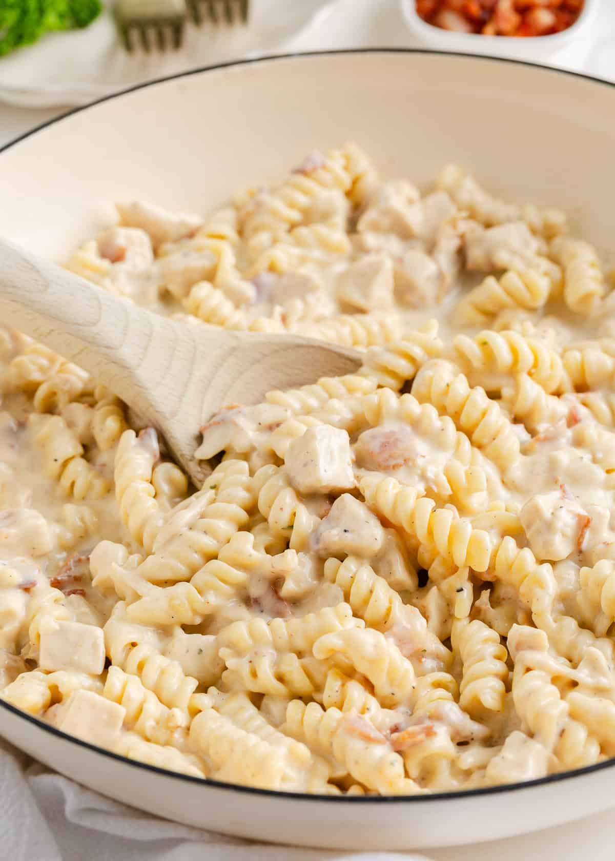 Stirring together chicken bacon ranch pasta.