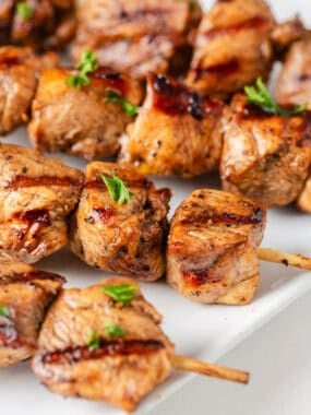 Chicken skewers on a plate.